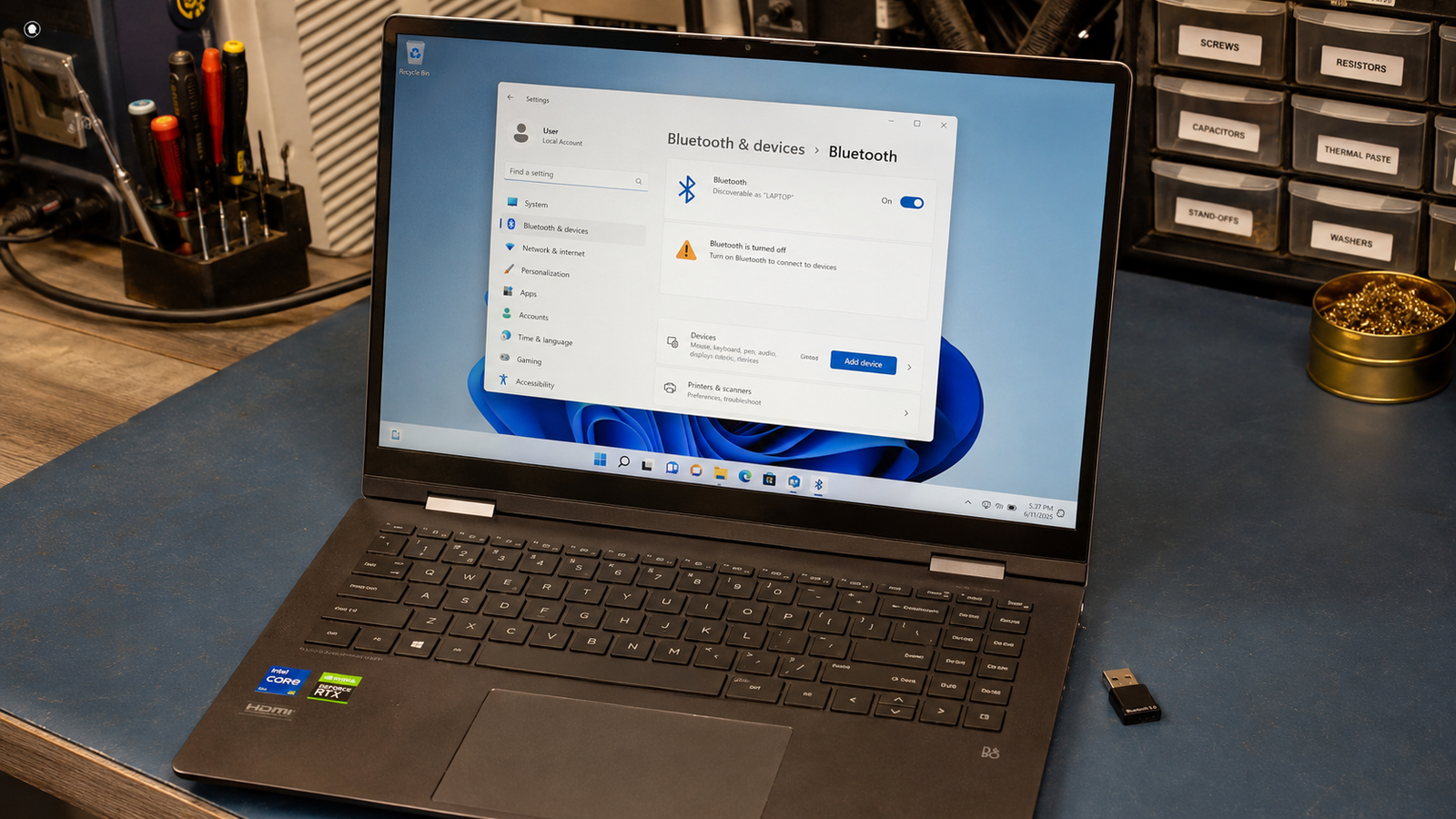 Laptop with Bluetooth not working showing Windows 11 settings panel open on clean repair bench