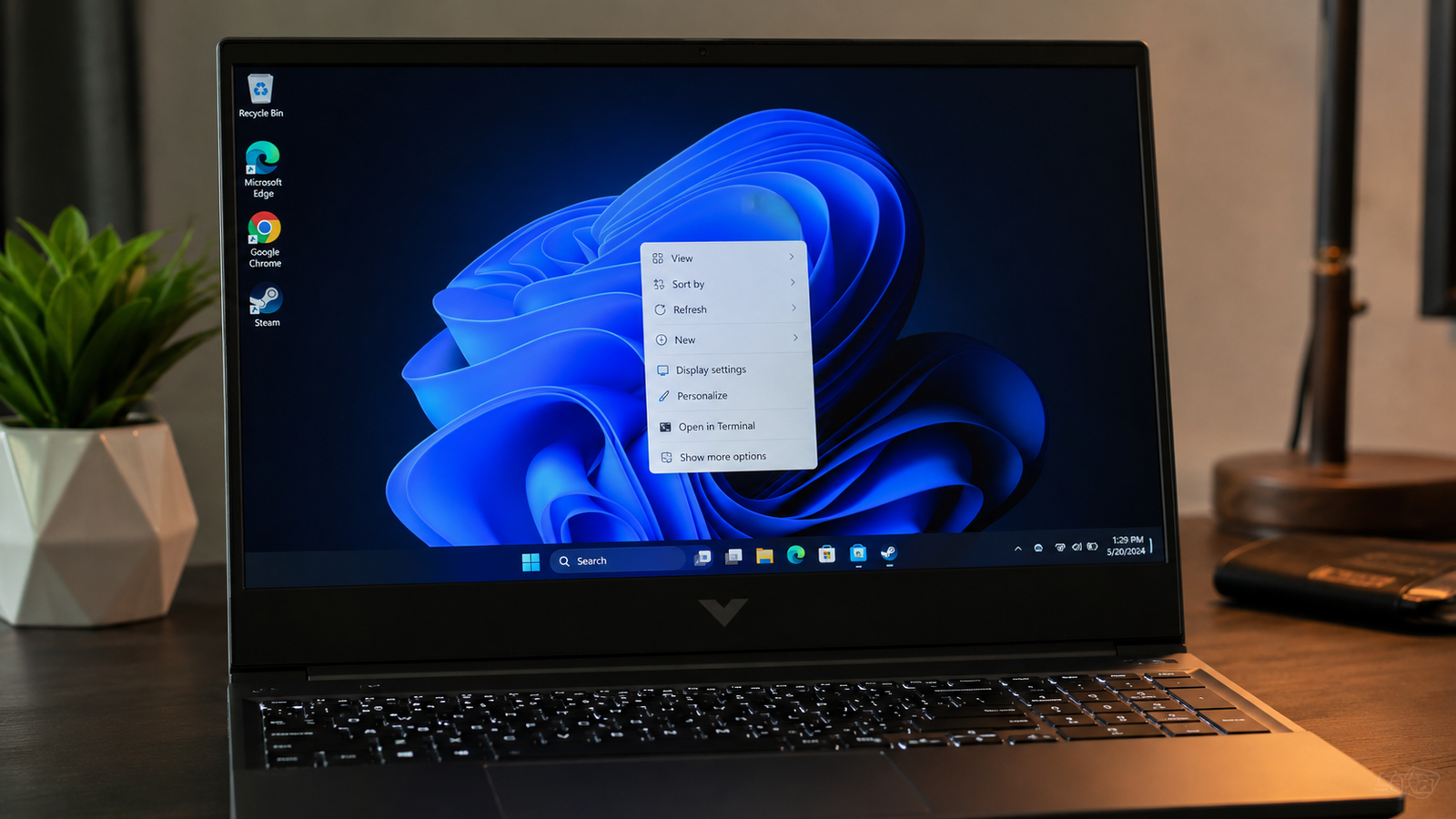 Laptop showing Windows desktop with right-click context menu missing the NVIDIA Control Panel option